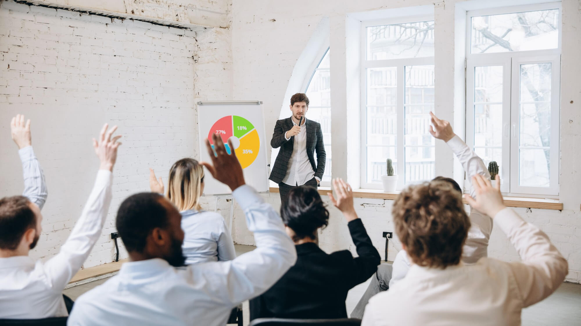 A leader presenting a development session to a group of colleagues.