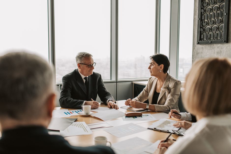 Two business leaders discussing a strategy in a bright office
