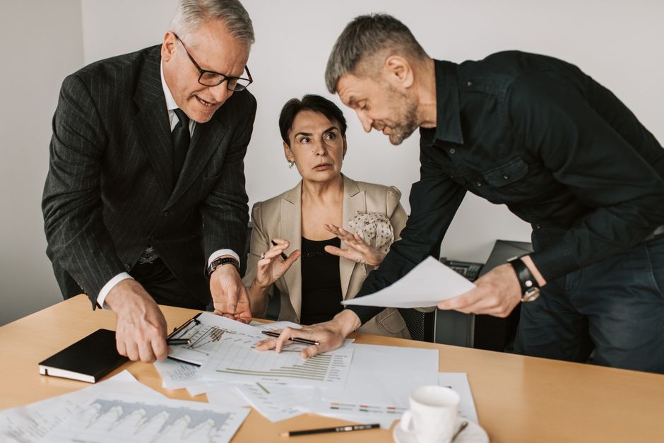 Colleagues reviewing plans together around a conference table