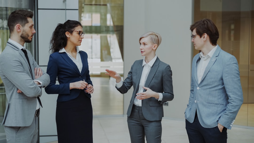 Business professionals listening to a leader during a workplace discussion